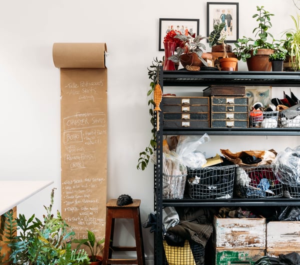 Plants and fabrics on shelves at Masami Clothing Gisborne.