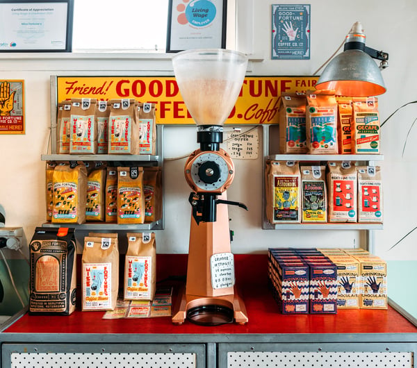 Coffee machine and bags of coffee on a colourful counter in Miss Fortune's cafe