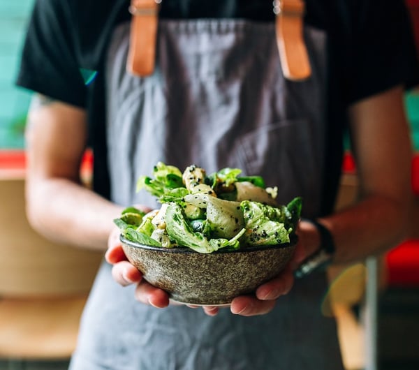 Person Holding a salad.