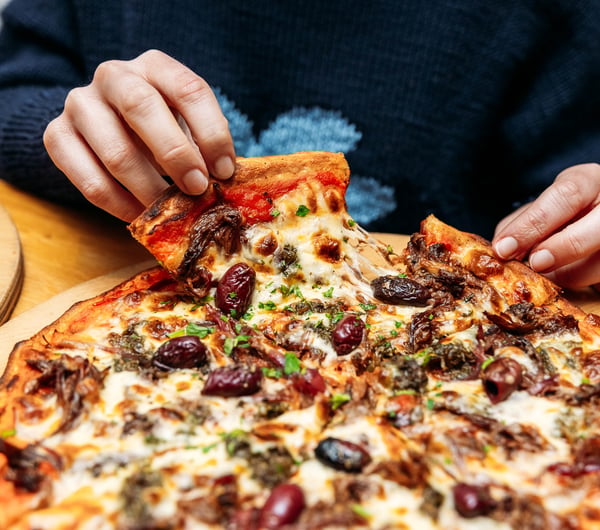 A close up of a large pizza on a table.