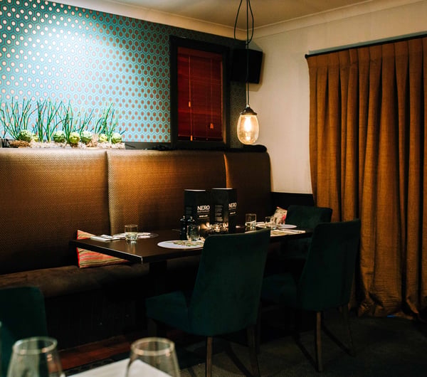 A cosy nook of the restaurant with blue tile.