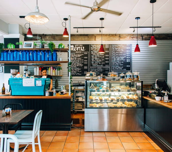 View of coffee machine and menu on the wall.
