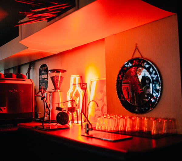 Red light decorations shines on drinks.