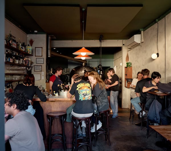 Looking through the doorway into a busy dining room at OOH-FA in Auckland