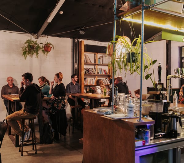 Customers sitting at high tables.