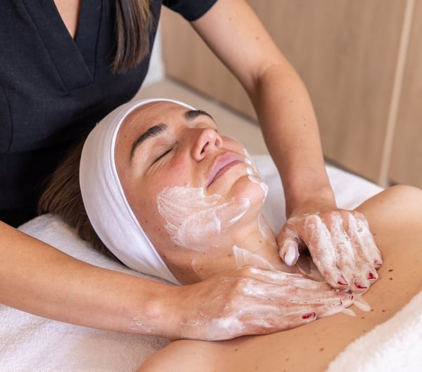 Close up of woman receiving a facial.