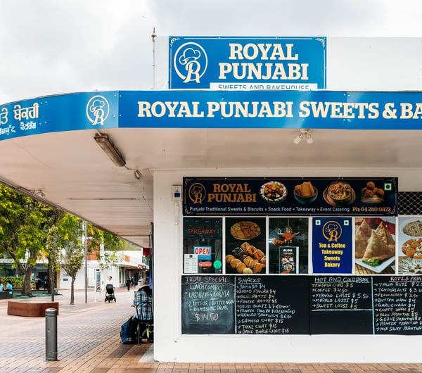 Exterior view of the corner shop Royal Punjabi Sweets and Bake House.