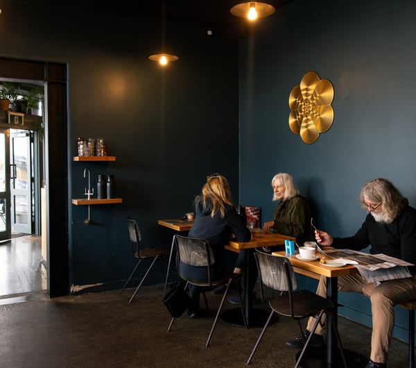 Customers dining inside a cafe painted blue.