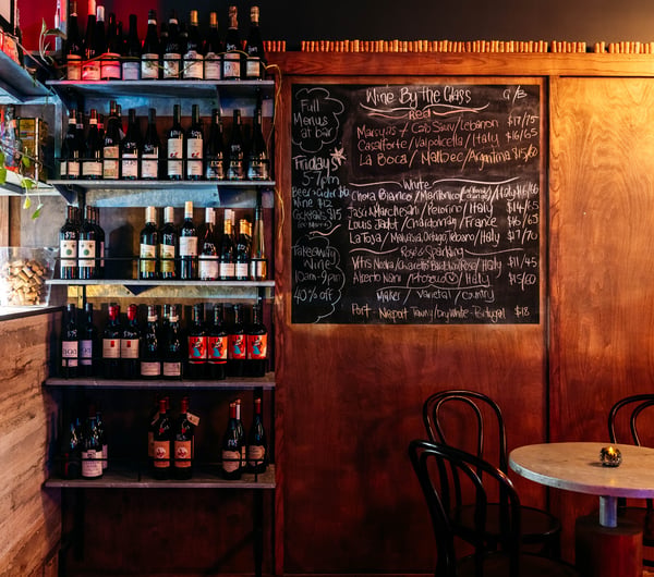 Wood panelling on the walls inside a dimly lite bar.