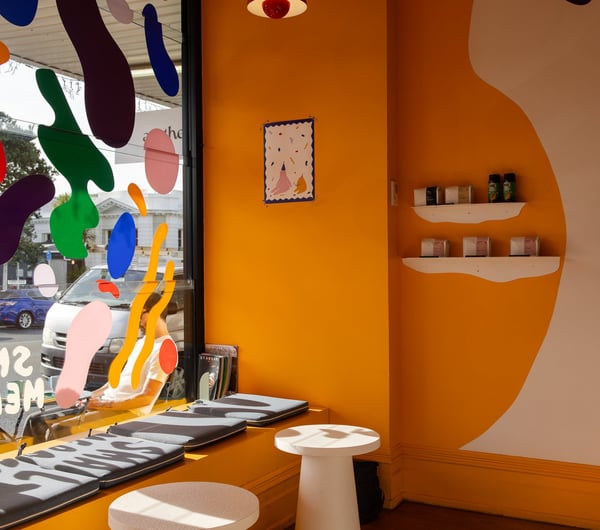 The yellow and white painted interior of Small Mercies Auckland.