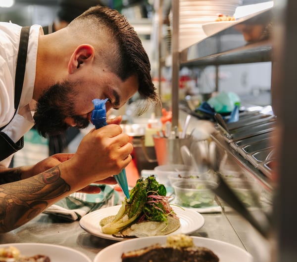 Chef preparing dish.