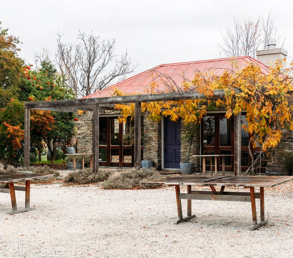 Schist building exterior and outdoor tables at Terra Sancta.