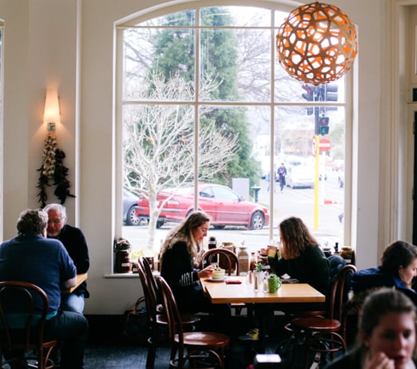 Customers dining in at tables by the window.
