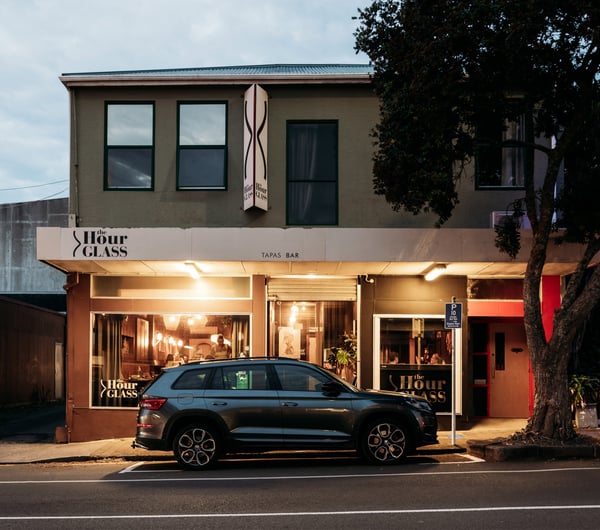 The exterior of The Hour Glass in New Plymouth at dusk.