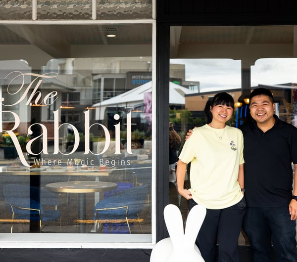 A man and woman standing in the entrance of The Rabbit restaurant, cafe and bar in Ashburton.