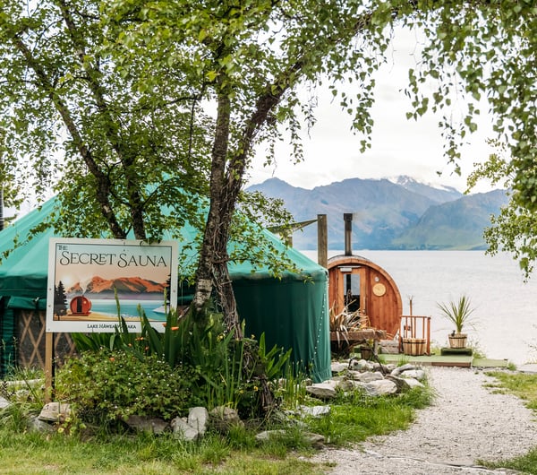 The Secret Sauna yurt and wooden sauna beside the lake.