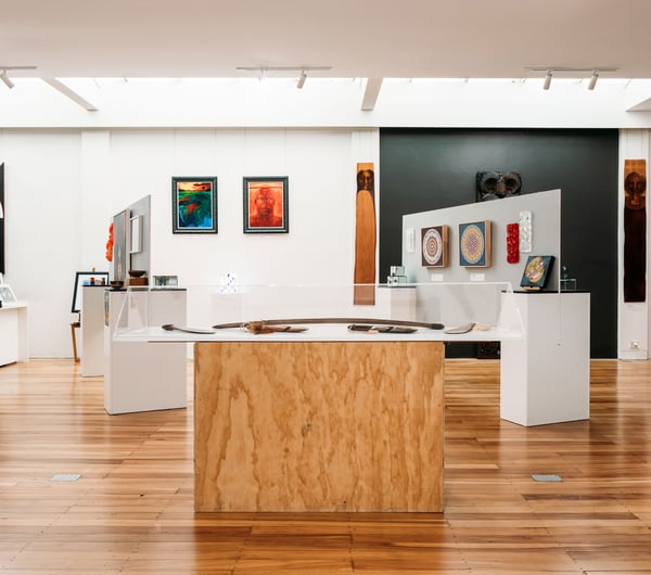 A large gallery full of colourful works of art.