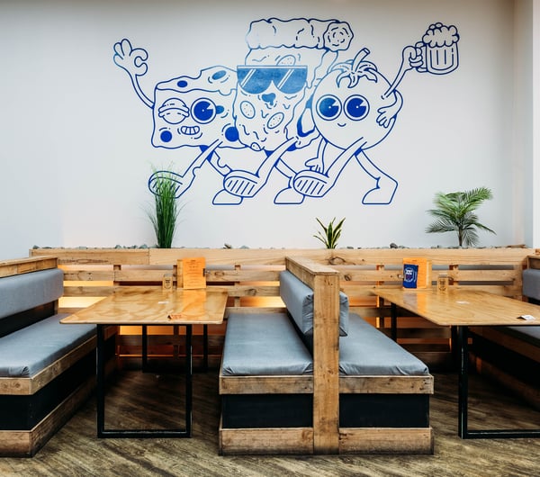 A blue illustration on a wall inside Tony's Pizza in Palmerston North.