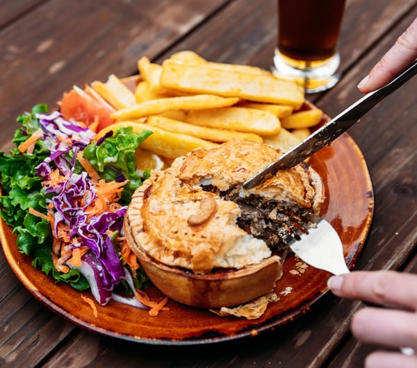 A close up of a pie being cut into.