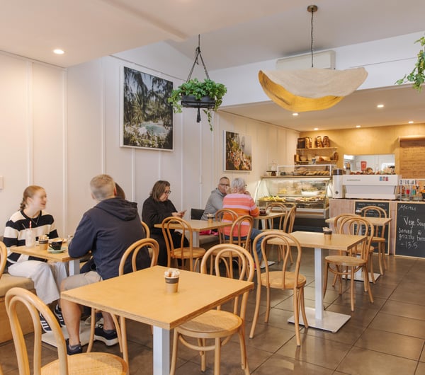 Busy cafe interior with customers at tables in Woods Cafe.