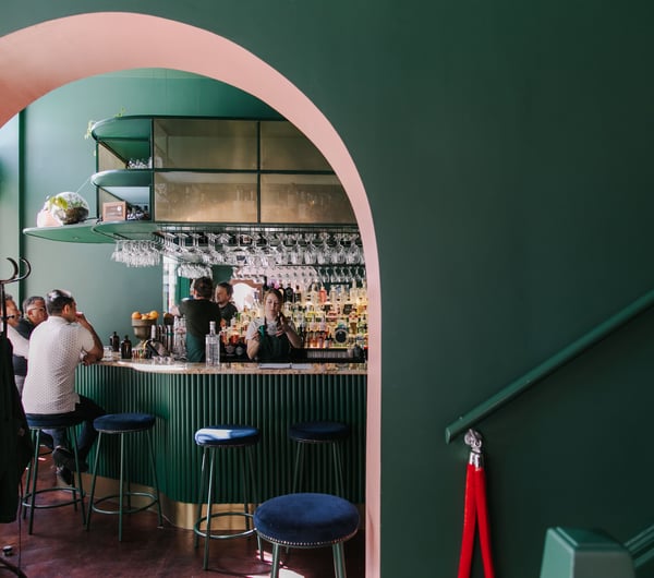 Interior view of gin gin feature green and pink contrast archway.