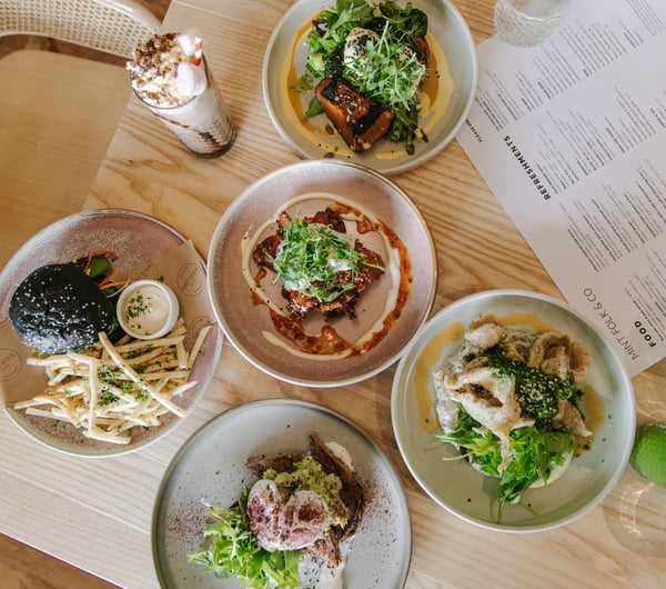 A flatlay of plates of food on a table at Mint Folk in Twizel.