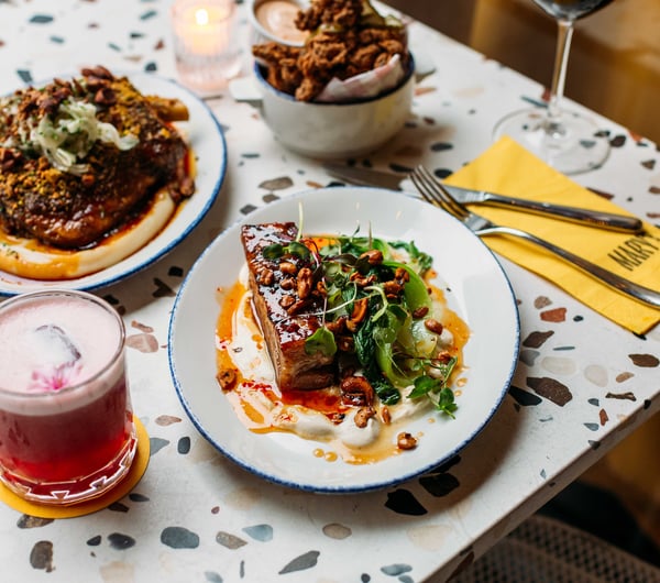 Plates of food on a terrazzo table inside Mary's in Havelock North.