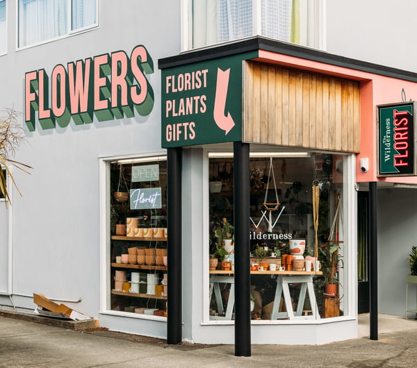 The green, pink and grey exterior of The Wilderness florist store in Paraparaumu.