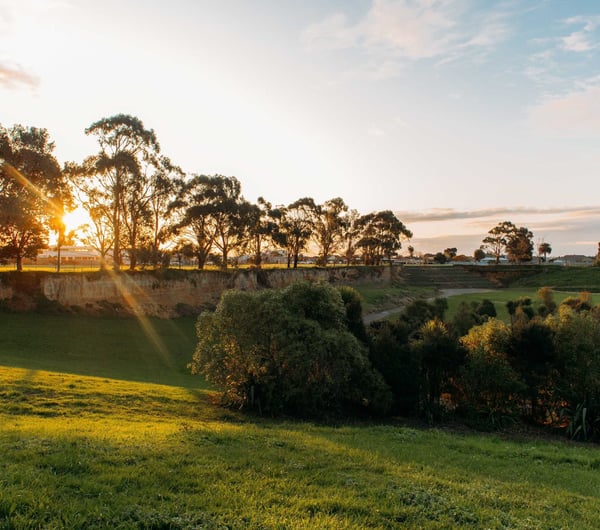 The sun setting over Edward Pit Park on a clear day.