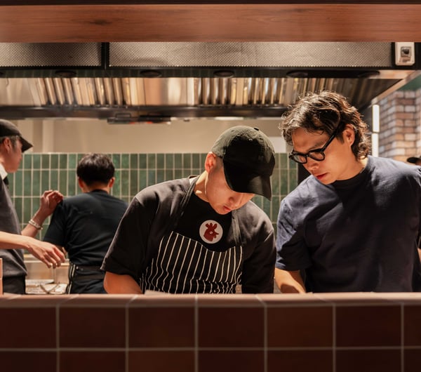 Two men working in a hot looking kitchen.