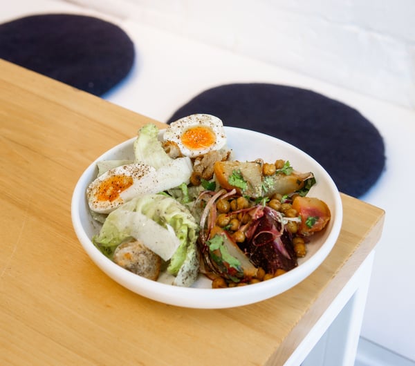 Bowl of fresh salad with a boiled egg on the table at Estelle Cafe in Christchurch