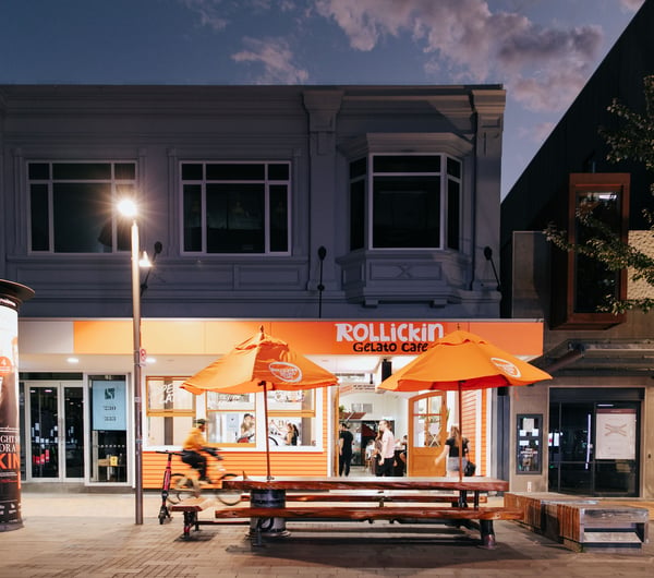 An orange cafe at night time.