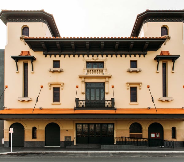 The peachy-orange exterior of the Hastings Municipal Building.