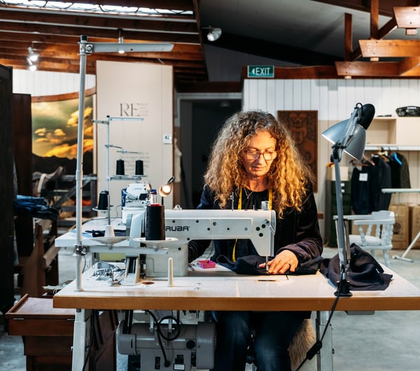 A woman working at a sewing machine.
