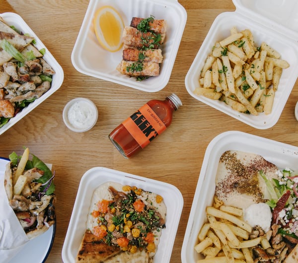 A flatlay of salads and hot chips on a table at Zeek's.