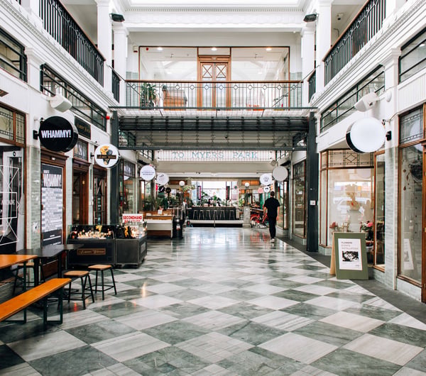 A covered arcade filled with shops.