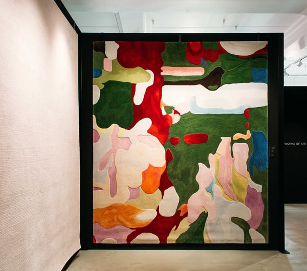 A colourful rug on a wall at Hanrad Bespoke Rugs Hamilton.