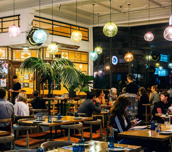 Customers dining under colourful bulbs at Gemmayze Street in Auckland.