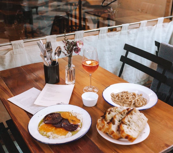 Pasta and bread on a table at Pick in Auckland.