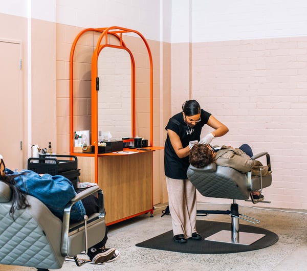 Women receiving treatment at Lab Brows and Body Hamilton.