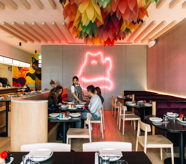 A group of customers sitting at a table inside Hello Beasty in Auckland.