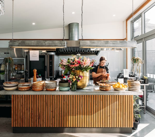 A woman working behind the cafe counter at Packing Shed.