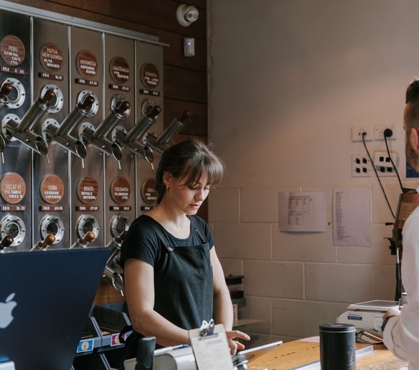 A woman working behind the counter at C4.