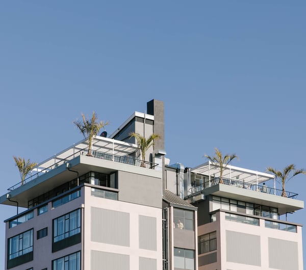 A view of the Pink Lady building looking up from the ground.
