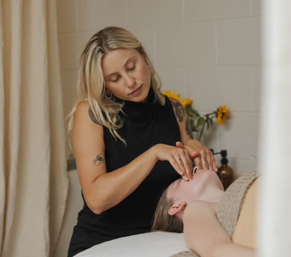 Beauty therapist at Face.it Sumner giving facial treatment to client
