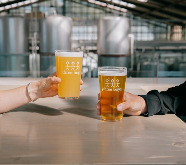 Two pints of Three Boys Brewery beers on the table.