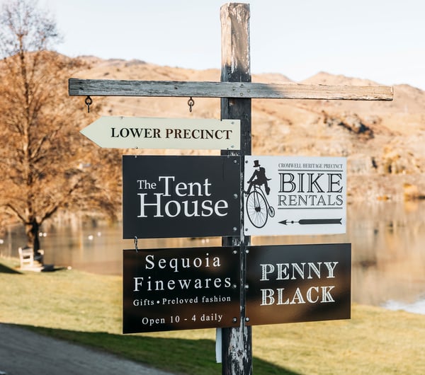 A lake view in Cromwell with signs in the forefront.