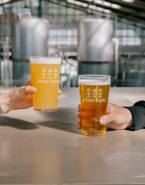 Two pints of Three Boys Brewery beers on the table.
