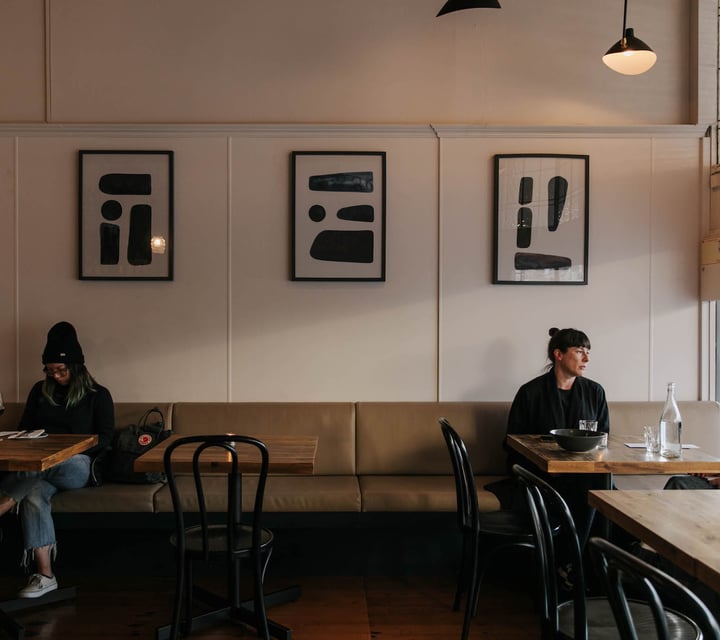 Customers sitting on a bench seat at Arden.