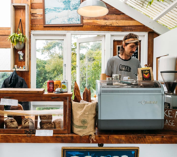 A staff member working behind the counter in the Bacca Bakery cafe.
